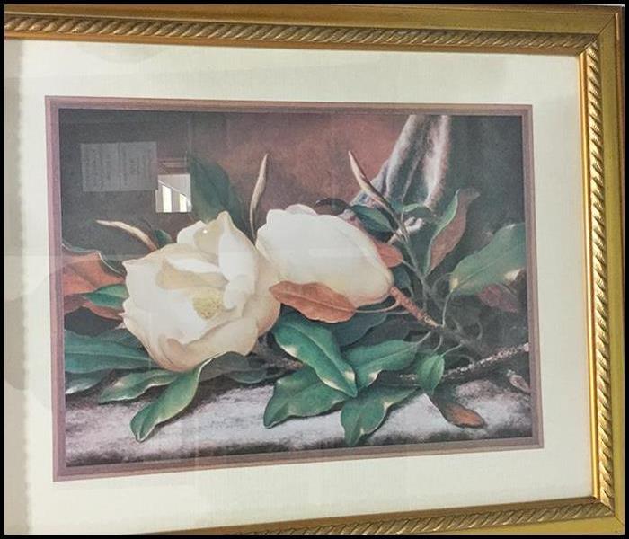A framed picture after soot cleanup services