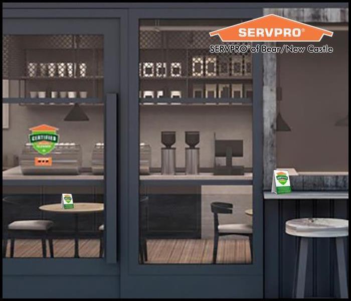An empty cafe with Certified: Servpro Clean signage
